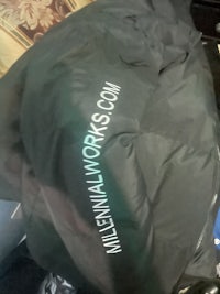 a black bag with the words whitney mcmoy com on it