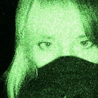 a woman with a green mask covering her face